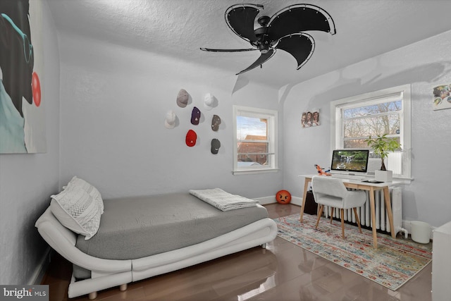 bedroom with a textured ceiling and ceiling fan