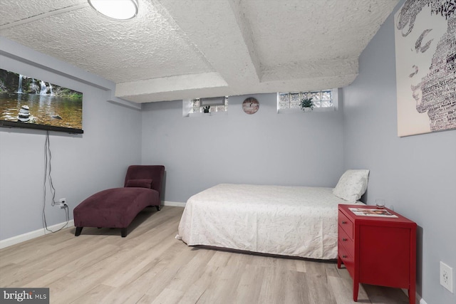 bedroom with wood-type flooring and a textured ceiling