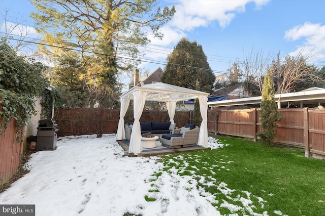 yard layered in snow featuring a gazebo and outdoor lounge area