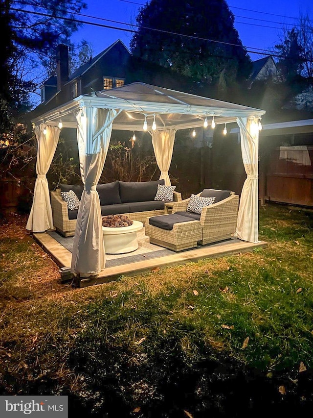 back of house with an outdoor hangout area, a gazebo, and a lawn