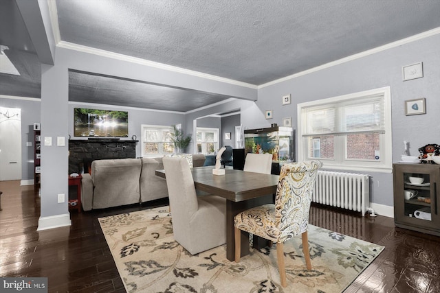 dining space with dark wood-type flooring, radiator heating unit, a textured ceiling, and ornamental molding