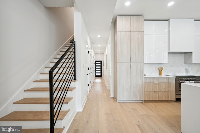 stairs with hardwood / wood-style floors