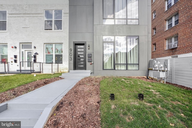 doorway to property featuring a lawn