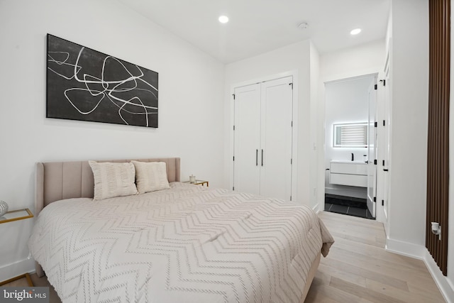 bedroom featuring light hardwood / wood-style flooring and a closet