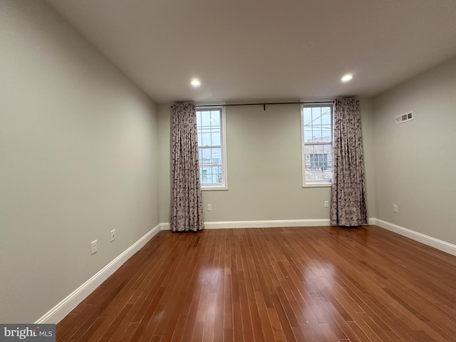 unfurnished room with wood-type flooring