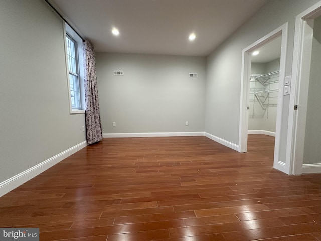 empty room with dark hardwood / wood-style flooring