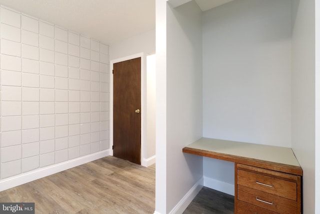 interior space with hardwood / wood-style floors and built in desk