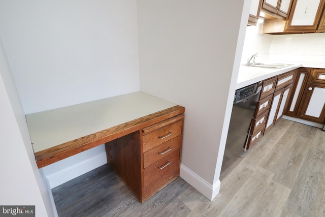 home office with light hardwood / wood-style floors and sink