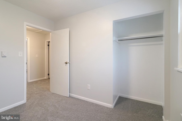 unfurnished bedroom with carpet flooring and a closet