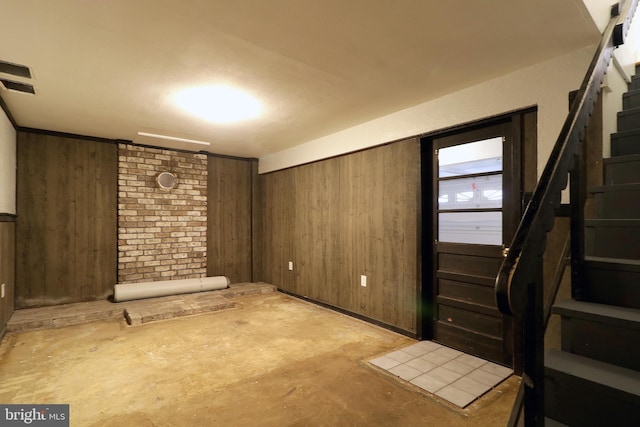 basement featuring wooden walls