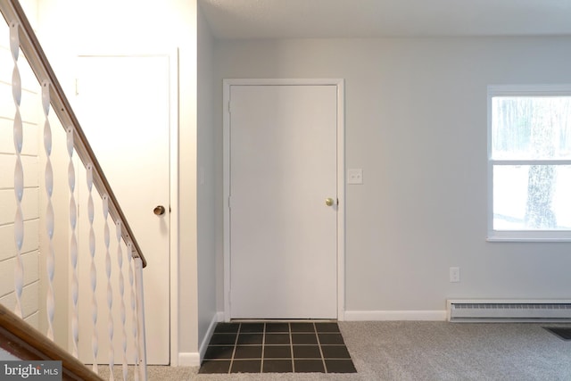 entrance foyer with carpet and a baseboard radiator