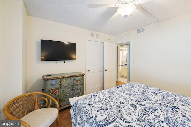 bedroom with ceiling fan and a textured ceiling