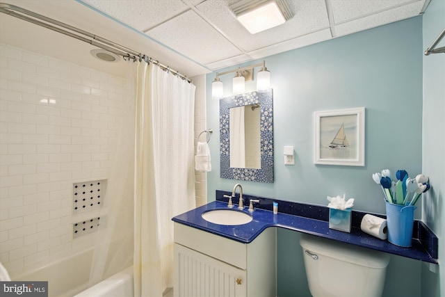 full bathroom featuring toilet, a paneled ceiling, vanity, and shower / bath combination with curtain