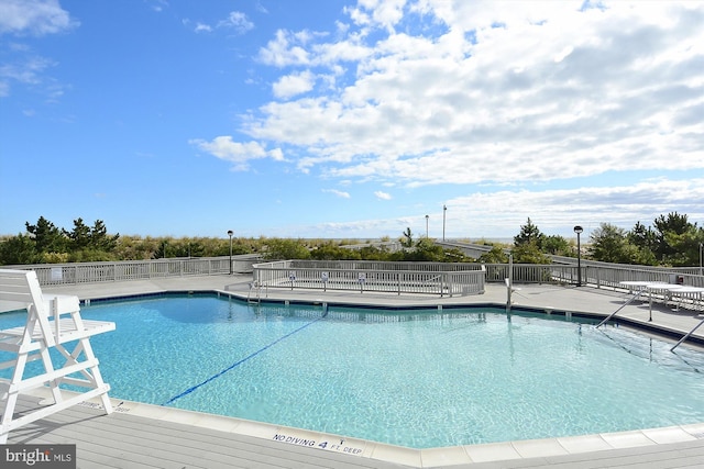 view of swimming pool featuring a patio area