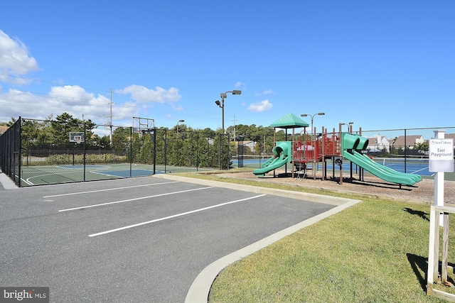 view of playground with tennis court, basketball court, and a lawn