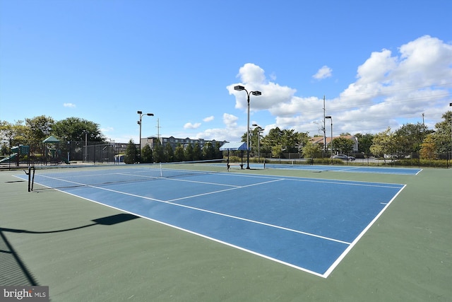 view of sport court with basketball court and a playground