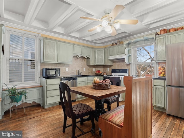 kitchen featuring beamed ceiling, appliances with stainless steel finishes, light wood-type flooring, and green cabinetry