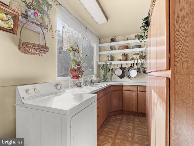 laundry room featuring cabinets, sink, washer / clothes dryer, and light parquet floors