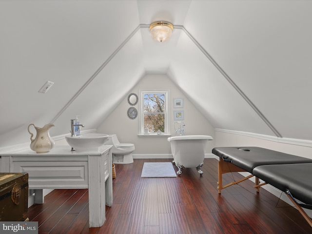 interior space with dark hardwood / wood-style floors, lofted ceiling, and sink