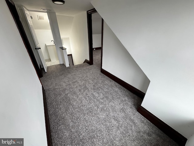 hall with dark carpet