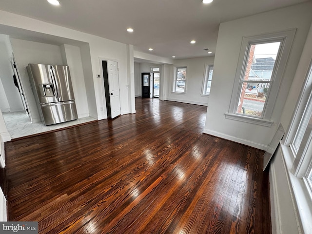 unfurnished living room with dark hardwood / wood-style flooring