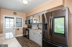 kitchen with gray cabinetry, black electric range oven, dark hardwood / wood-style floors, stainless steel fridge, and ornamental molding