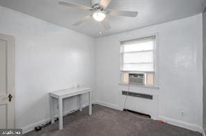 interior space featuring ceiling fan, cooling unit, and dark colored carpet