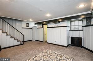 basement with light carpet and radiator