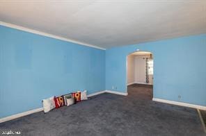 unfurnished room featuring dark carpet