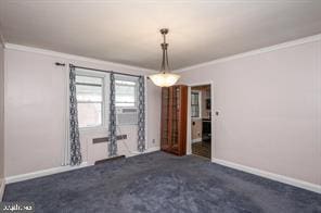 unfurnished room featuring crown molding and dark carpet