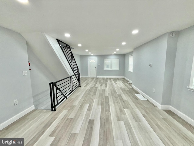 basement with light hardwood / wood-style floors