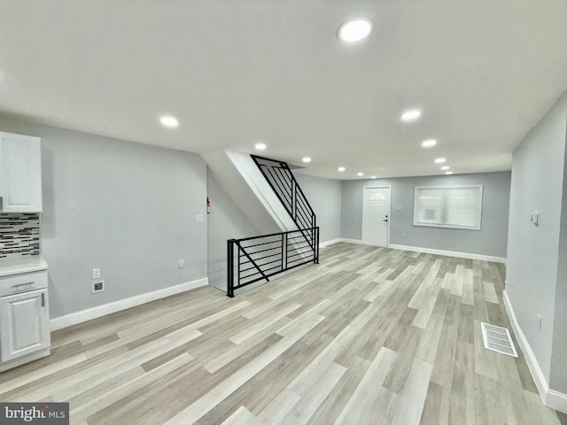 basement with light hardwood / wood-style floors