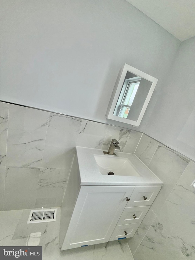 bathroom with vanity and backsplash