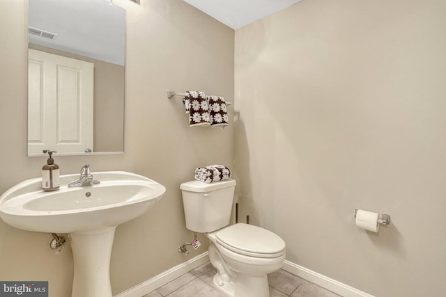 bathroom with tile patterned flooring and toilet