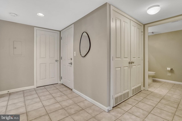 tiled foyer entrance with electric panel