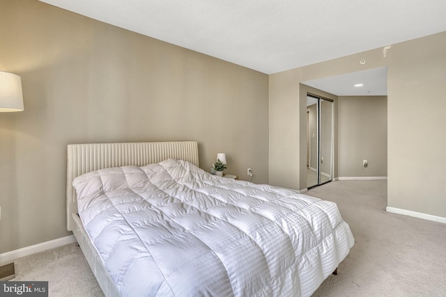 bedroom featuring light carpet and a closet