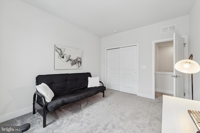 sitting room featuring light colored carpet