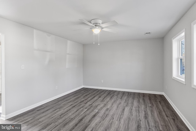 spare room featuring ceiling fan and dark hardwood / wood-style floors