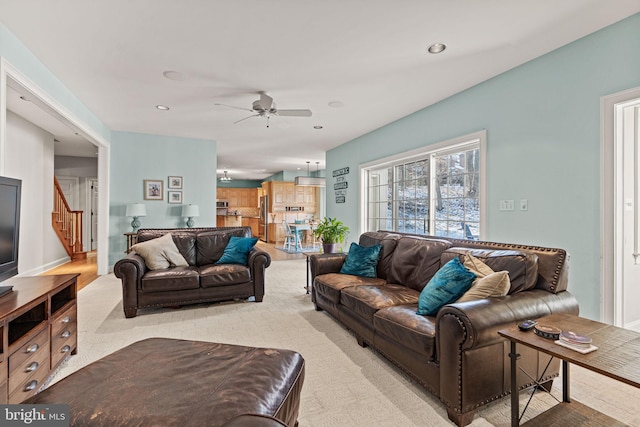 carpeted living room featuring ceiling fan