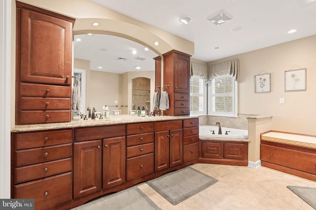 bathroom featuring tile patterned flooring, vanity, and separate shower and tub