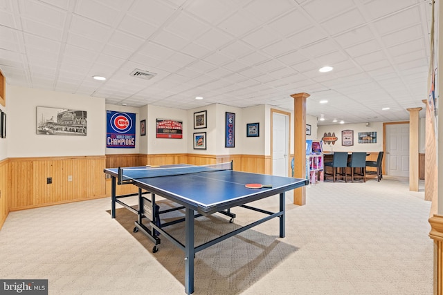 rec room featuring bar area, light carpet, and decorative columns