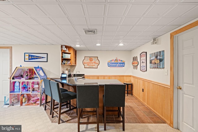 interior space with bar and wood walls