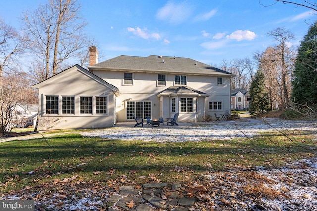 back of house with a yard and a patio