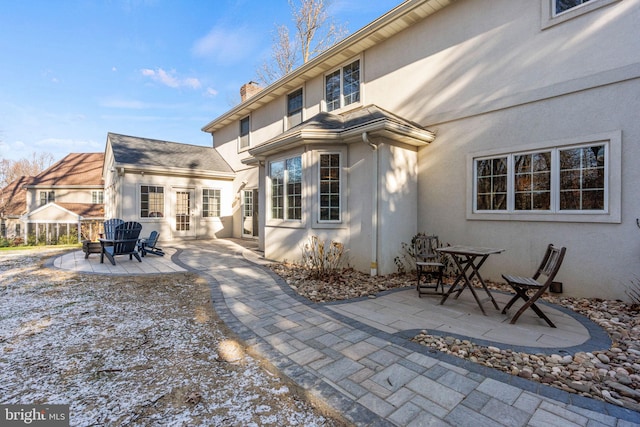 back of property featuring a patio