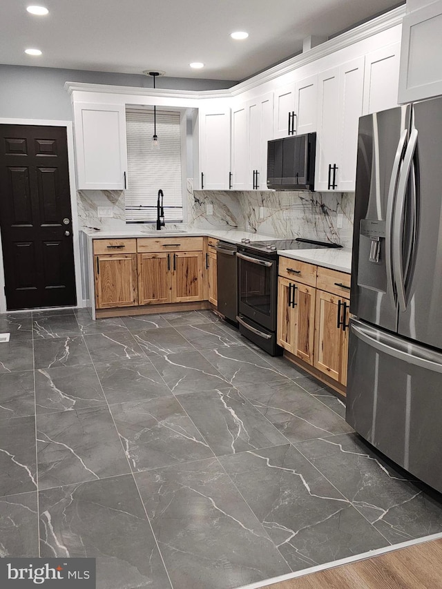 kitchen with white cabinets, backsplash, sink, and stainless steel appliances