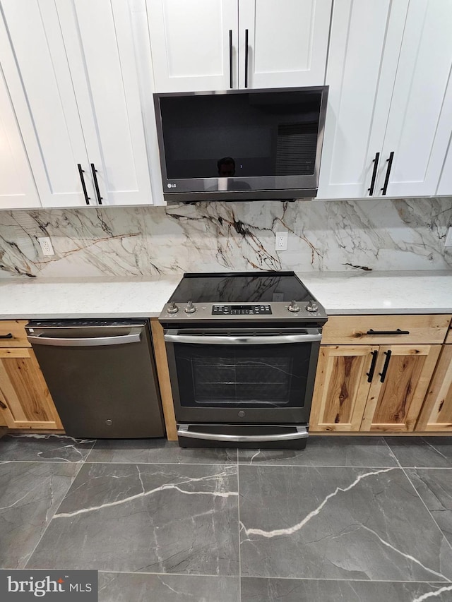 kitchen featuring backsplash, stainless steel appliances, and white cabinetry