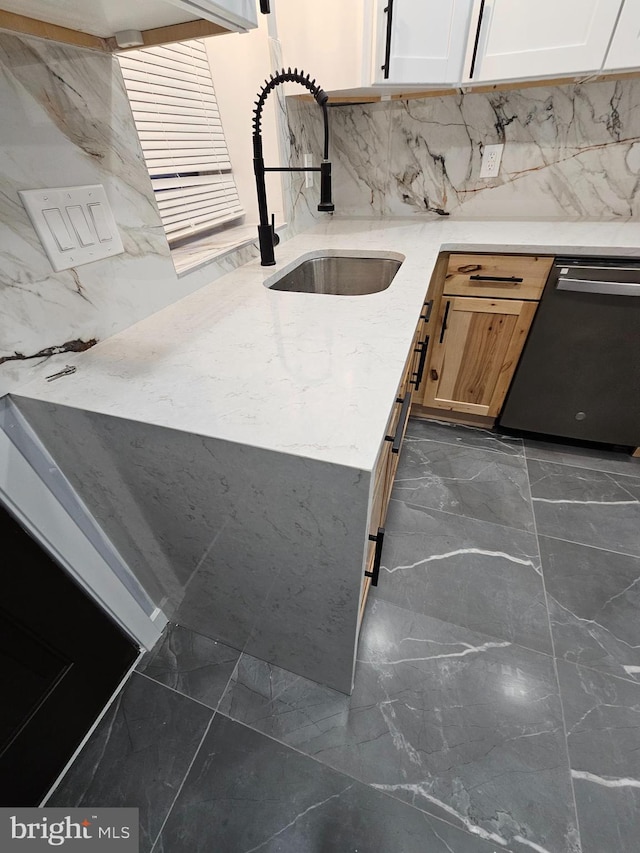 kitchen featuring dishwasher, light brown cabinets, backsplash, sink, and white cabinetry