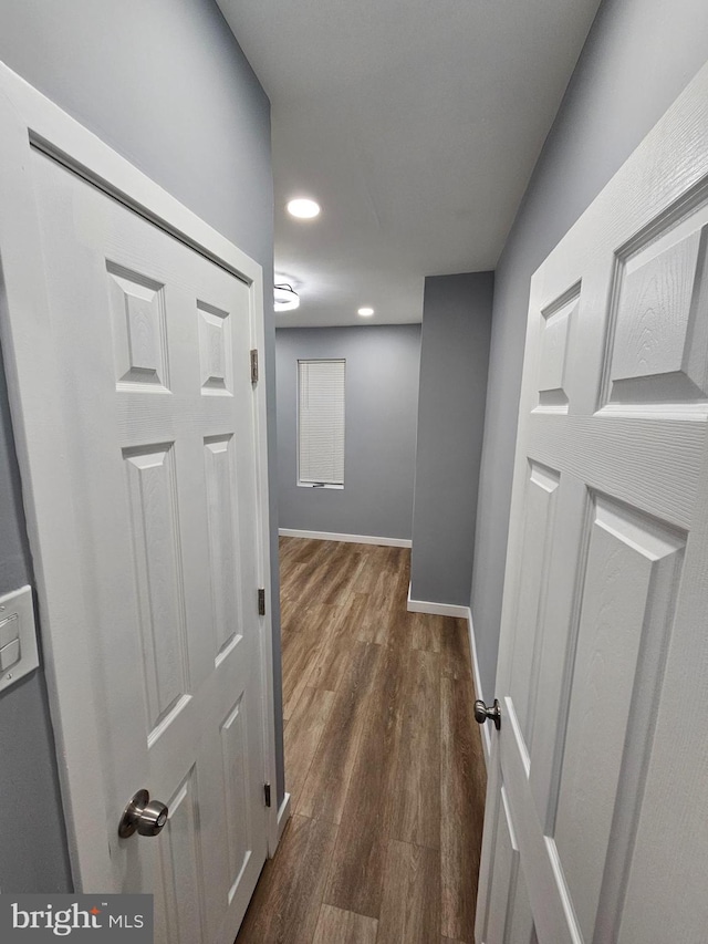 hallway with dark hardwood / wood-style floors