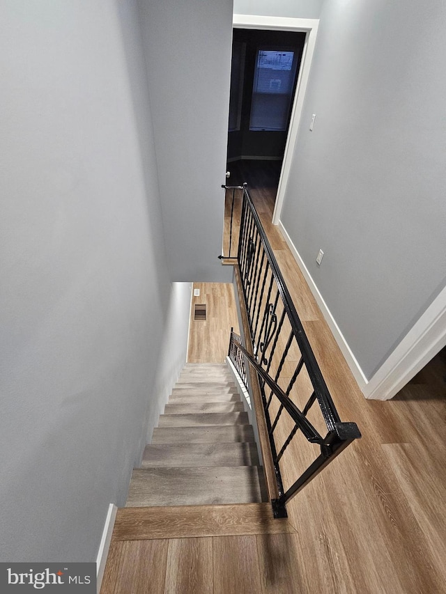 stairway with wood-type flooring