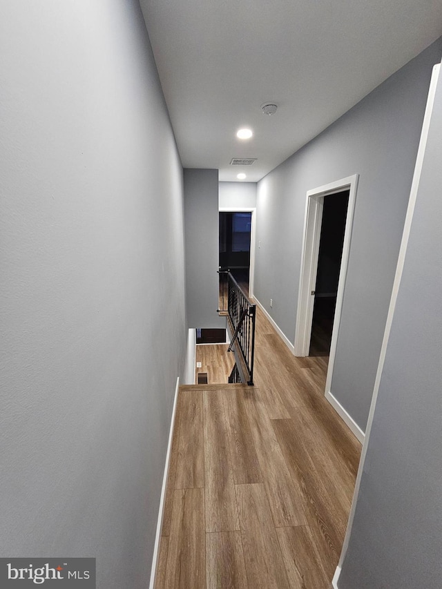 corridor with light hardwood / wood-style flooring